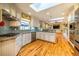 Open-concept kitchen boasts stainless appliances, granite counters, tiled backsplash, and hardwood floors at 708 Kenmore Rd, Chapel Hill, NC 27514