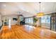 Bright and airy living room featuring hardwood floors, large windows, and a fireplace at 708 Kenmore Rd, Chapel Hill, NC 27514