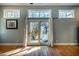 Living room with hardwood floors, light gray walls and glass doors to a patio at 708 Kenmore Rd, Chapel Hill, NC 27514