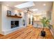 Cozy living room featuring fireplace, wood floors, and an attached kitchen at 708 Kenmore Rd, Chapel Hill, NC 27514