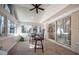 Bright sunroom with tiled flooring, chair rail, brick accent wall, and large windows providing plenty of natural light at 708 Kenmore Rd, Chapel Hill, NC 27514