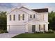 Charming two-story home boasts a manicured lawn, attached two-car garage, and welcoming entrance at 7568 Tanager Dr, Snow Camp, NC 27349