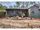Backyard with patio, mature trees, and grey siding at 7925 Brown Bark Pl, Raleigh, NC 27615