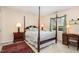 Traditional primary bedroom with four poster bed, bedside tables, and oriental rug at 7925 Brown Bark Pl, Raleigh, NC 27615