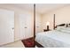 Bedroom with four poster bed, oriental rug, and double closets at 7925 Brown Bark Pl, Raleigh, NC 27615