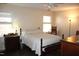 Bedroom features a ceiling fan, neutral walls, and wood furniture at 7925 Brown Bark Pl, Raleigh, NC 27615