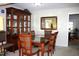 Formal dining area with ample seating, stylish furniture, and a built-in china cabinet at 7925 Brown Bark Pl, Raleigh, NC 27615