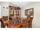 Formal dining area with ample seating, stylish furniture, and a built-in china cabinet at 7925 Brown Bark Pl, Raleigh, NC 27615