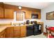 Functional kitchen with wooden cabinets and updated appliances, perfect for everyday cooking at 7925 Brown Bark Pl, Raleigh, NC 27615