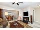 Comfortable living room with fireplace, open to the dining area for easy entertaining at 7925 Brown Bark Pl, Raleigh, NC 27615