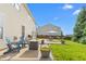 Outdoor living space with patio, chairs, and lush landscaping in a backyard setting at 80 Ingle View Ct, Burlington, NC 27215