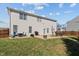 Spacious backyard featuring a concrete patio, grill, and outdoor seating, perfect for entertaining and relaxing at 80 Ingle View Ct, Burlington, NC 27215