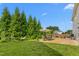 Grassy backyard featuring an outdoor dining area with a hammock for relaxation at 80 Ingle View Ct, Burlington, NC 27215