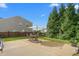 Relaxing backyard with patio, table and umbrella, and hammock on a sunny day at 80 Ingle View Ct, Burlington, NC 27215