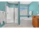 Bathroom featuring a separate shower and bathtub, light blue walls, and updated fixtures at 80 Ingle View Ct, Burlington, NC 27215