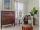 An accent chair is paired with vintage decor in this comfortable bedroom area with bright natural light at 80 Ingle View Ct, Burlington, NC 27215