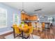 Dining area with wooden table, modern light fixture, and stainless steel appliances in the kitchen at 80 Ingle View Ct, Burlington, NC 27215