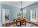 Cozy dining area with wood table, modern lighting, and natural light from the window at 80 Ingle View Ct, Burlington, NC 27215