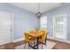Dining area with wooden table, modern light fixture, and view to the outside at 80 Ingle View Ct, Burlington, NC 27215