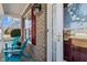 Inviting front porch with brick facade and blue Adirondack chairs, creating a cozy entrance at 80 Ingle View Ct, Burlington, NC 27215