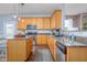 Kitchen with wooden cabinets, island, granite counters, and stainless steel appliances at 80 Ingle View Ct, Burlington, NC 27215