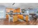 Open kitchen with stainless steel appliances, granite countertops, and a cozy breakfast bar at 80 Ingle View Ct, Burlington, NC 27215