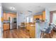 Well-lit kitchen with wood cabinets, stainless steel appliances, and breakfast bar with seating at 80 Ingle View Ct, Burlington, NC 27215