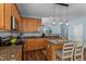Modern kitchen with wooden cabinets, island with seating, and stylish pendant lights at 80 Ingle View Ct, Burlington, NC 27215
