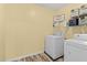 An organized laundry room featuring modern appliances, functional shelving, and decor for a practical space at 80 Ingle View Ct, Burlington, NC 27215