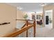 Bright living room featuring neutral walls and furnishings, with a glimpse of a hall and rocking chair through a doorway at 80 Ingle View Ct, Burlington, NC 27215