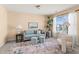 Cozy living room area featuring a comfortable sofa, decorative rug, accent chair, and plenty of natural light at 80 Ingle View Ct, Burlington, NC 27215