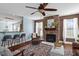Comfortable living room with a stone fireplace, stylish seating, hardwood floors, and an open layout at 80 Ingle View Ct, Burlington, NC 27215