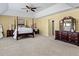Bright and airy primary bedroom featuring a canopy bed, recessed ceiling, and a traditional style at 80 Ingle View Ct, Burlington, NC 27215