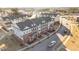 Aerial view of townhomes featuring brick and siding exteriors, sidewalks, and well-maintained landscaping at 978 Gateway Commons Cir, Wake Forest, NC 27587