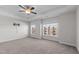 Light-filled bedroom with neutral tones features a tray ceiling, carpeted floors and double windows at 978 Gateway Commons Cir, Wake Forest, NC 27587