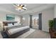 Comfortable bedroom features a luxurious bed, tray ceiling and calming gray and white decor at 978 Gateway Commons Cir, Wake Forest, NC 27587