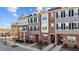 Exterior angle view of townhomes with brick and gray siding under a blue sky at 978 Gateway Commons Cir, Wake Forest, NC 27587