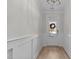 Bright foyer with hardwood floors and white wainscoting leading to the front door at 978 Gateway Commons Cir, Wake Forest, NC 27587