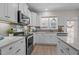 Well-lit kitchen with white cabinets, stainless appliances, and a view from the window above the sink at 978 Gateway Commons Cir, Wake Forest, NC 27587