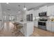 Modern kitchen features stainless steel appliances, pendant lighting, and a large island with bar seating at 978 Gateway Commons Cir, Wake Forest, NC 27587