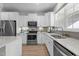 Bright kitchen boasts white cabinets, stainless steel appliances, and a double sink under a window at 978 Gateway Commons Cir, Wake Forest, NC 27587