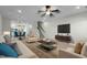 Comfortable living room with plush seating, a dark wood coffee table, and a staircase in view at 978 Gateway Commons Cir, Wake Forest, NC 27587