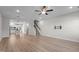 Open-concept living area with hardwood floors, a staircase, and contemporary lighting at 978 Gateway Commons Cir, Wake Forest, NC 27587