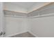 Walk-in closet with carpeted floors, wood shelving, and great storage space at 978 Gateway Commons Cir, Wake Forest, NC 27587