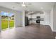 Open floor plan with stainless appliances, a ceiling fan, and a sliding door to the backyard at 103 Flue Ct, Oxford, NC 27565