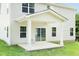 Covered back porch showcasing white pillars and a sliding glass door entrance to the home at 1032 Country Pasture Cv, Wendell, NC 27591
