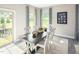 Cozy dining room with natural light, a modern table, and stylish decor at 1032 Country Pasture Cv, Wendell, NC 27591
