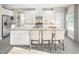 Bright, modern kitchen with white cabinets, a large center island, and stainless steel appliances at 1032 Country Pasture Cv, Wendell, NC 27591