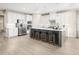 Large kitchen with white cabinets, stainless steel appliances, central island and bar stool seating at 1032 Country Pasture Cv, Wendell, NC 27591