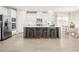 Bright kitchen with white cabinets, stainless steel appliances, a large island, and a dining area with seating at 1032 Country Pasture Cv, Wendell, NC 27591